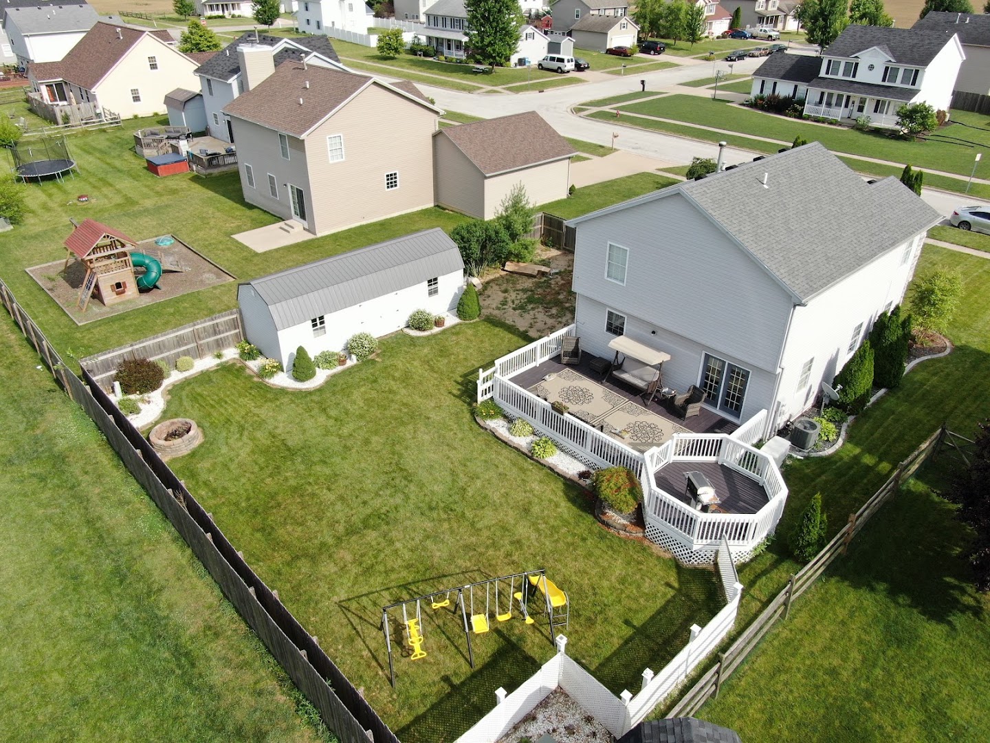Aerial real estate photograph showing a landscaped backyard and residential property